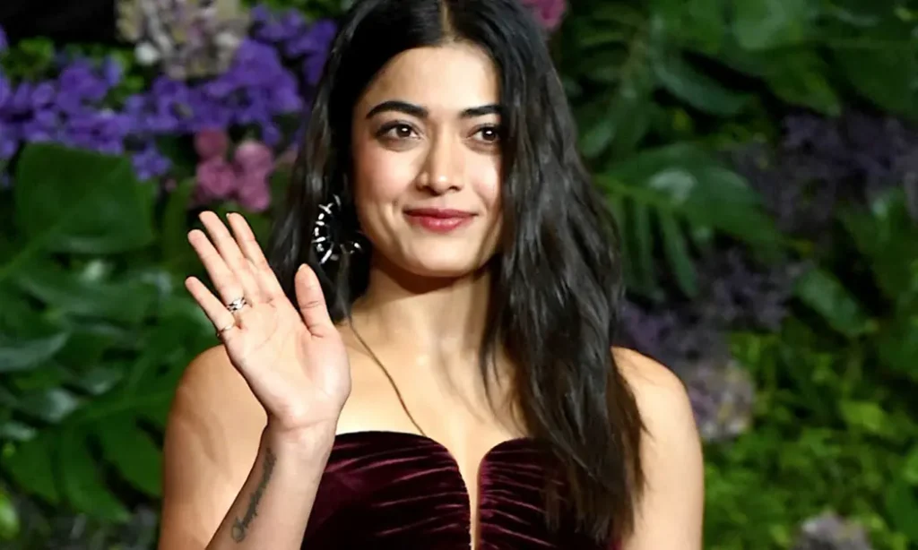Rashmika Mandanna smiling in a colourful traditional outfit