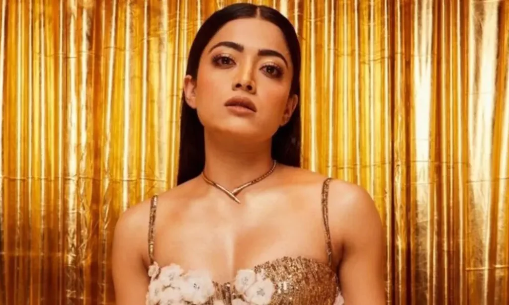 Rashmika Mandanna posing in a glamorous golden outfit